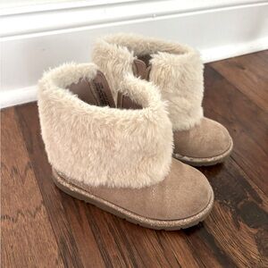 A pair of the cutest fuzzy boots for.The fur is super soft and warm.